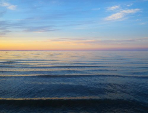 Tiny waves ripple in across the shallows